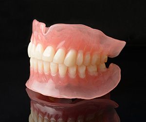 full dentures with a black background