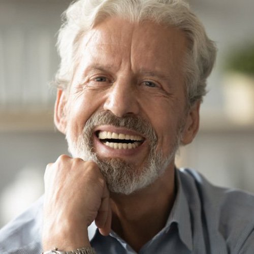 Patient in Naples smiling with dentures