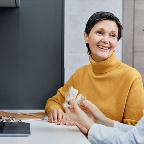 Patient in Naples discussing dentures with dentist