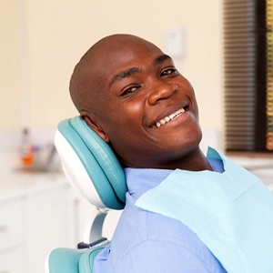 Man smiles while visiting his Naples implant dentist